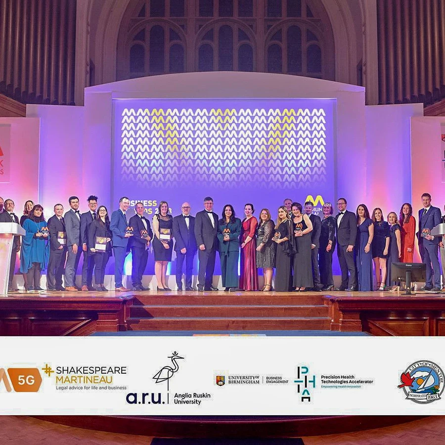 Group of award winners on stage at a corporate awards ceremony