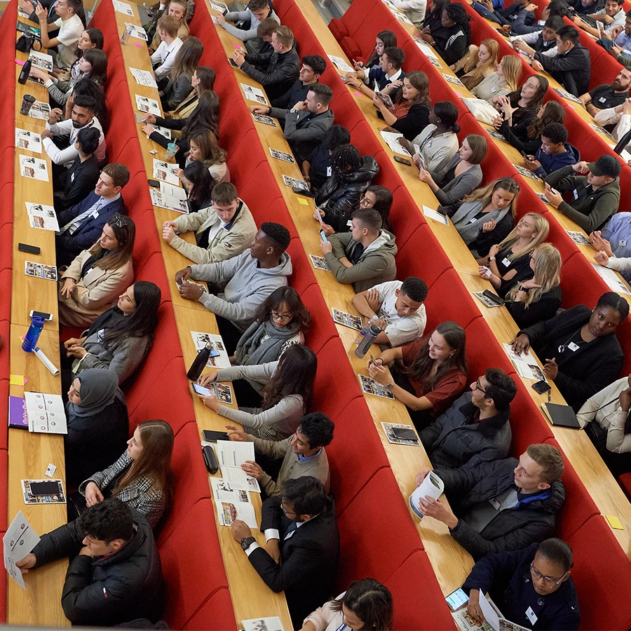 Delegates seated in a lecture hall during a corporate conference
