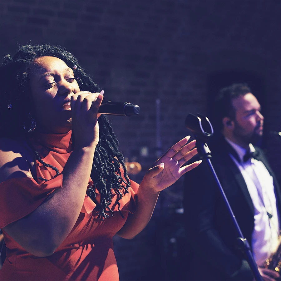 Singer performing with live band at a corporate event