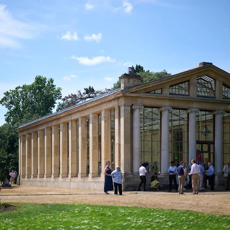 Guests networking outside a historic venue during a corporate event